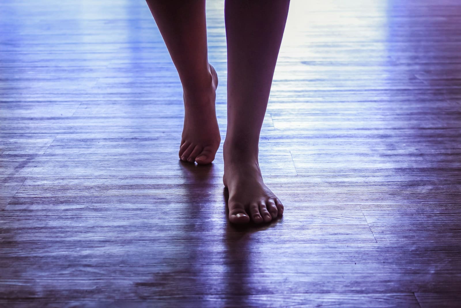 Barefoot walking on a wooden floor
